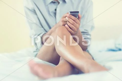 Mid section picture of pretty model holding mobile phone Stock Photos