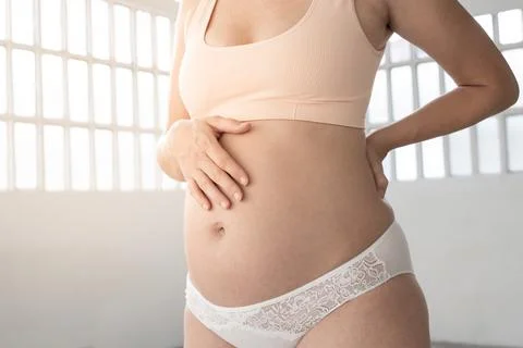 Mid-section portrait of unrecognizable young beautiful woman on second trimester Stock Photos
