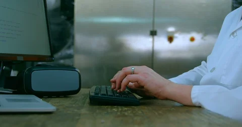 Mid section of robotic engineer using desktop pc at desk 4k Stock Footage 99846767
