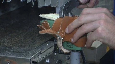 Mid-section of shoemaker repairing a shoe in workshop  動画素材 90371910