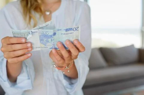 Mid section view of a girl holding paper currency Stock Photos