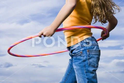Mid Section View Of Girl With Hula Hoop Outdoors With Clouds