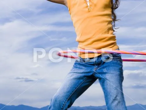 Mid Section View Of Girl With Hula Hoop Outdoors With Clouds