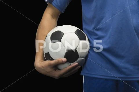 Mid section view of a soccer player with a soccer ball Stock Photos
