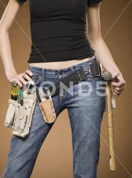 Mid Section View Of Woman With Tool Belt