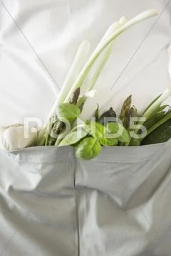 Mid Section View Of A Woman With Vegetables In The Kitchen