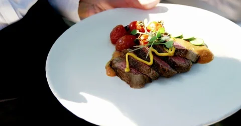 Mid-section of waitress holding tray of breakfast Vidéo 72825011