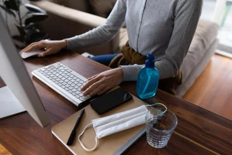 Mid section of woman using computer at home Fotos de archivo