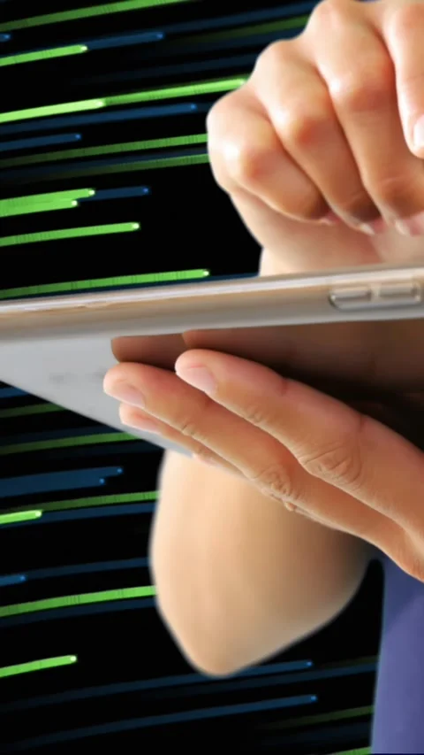 Mid section of woman using digital tablet against light trails moving on black Stock Footage 323781572