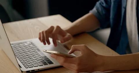 Mid section of woman using laptop and smartphone Stock Footage 142200749