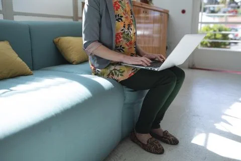 Mid section of woman using laptop Photos