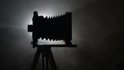Mid shot of bearded photographer adjusting old vintage wooden photo camera and Vídeos de archivo 75921006