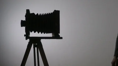 Mid shot of bearded photographer adjusting old vintage wooden photo camera and 스톡 동영상 75921522