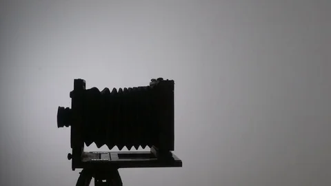 Mid shot of bearded photographer adjusting old vintage wooden photo camera and 動画素材 75921799