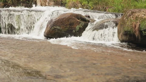 Mid shot, clean and pure white water flowing thru creek stones Stock Footage 152201723