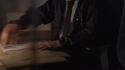 Mid Shot of FBI agent looking a documents Видео 312455624