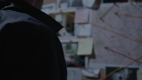 Mid shot of FBI agent reading Evidence Board Stock Footage 312455361