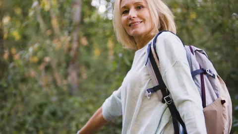 Mid-shot front view of cheerful group of coworkers reviewing details of Stock Footage 278019648