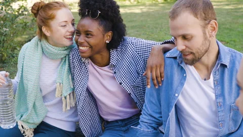 Mid-shot front view of cheerful group of coworkers going over details of new Stock Footage 278021074