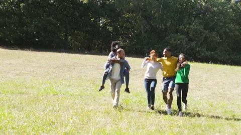 Mid-shot front view of cheerful group of coworkers going over details of new Stock Footage 278021410