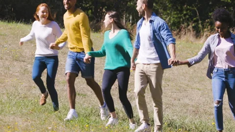 Mid-shot front view of cheerful group of coworkers going over details of new Stock Footage 278021679