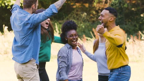 Mid-shot front view of cheerful group of coworkers going over details of new Stock Footage 278021935