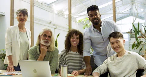 Mid-shot front view of diverse group of coworkers looking at camera while taking Stock Footage 277947654
