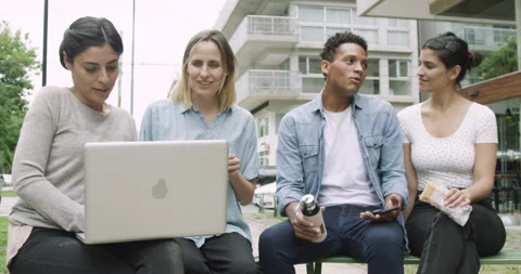 Mid-shot front view of diverse group of coworkers hanging out in an outdoors Stock Footage 277966076
