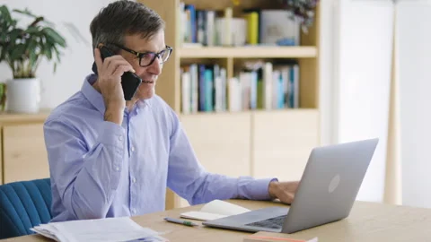 Mid-shot front view of diverse group of coworkers chatting and looking at Stock Footage 278041056