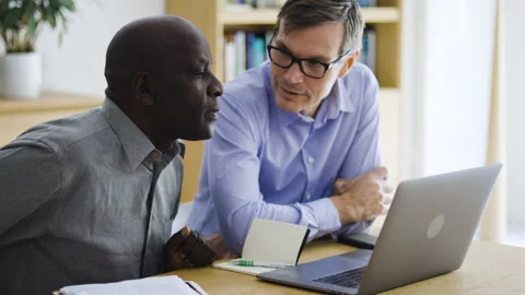 Mid-shot front view of diverse group of coworkers chatting and looking at Stock Footage 278041391