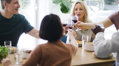 Mid-shot front view of diverse group of coworkers chatting and looking at Stock Footage 278041611