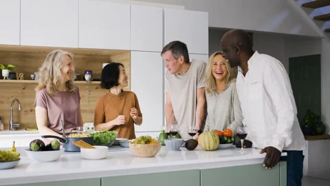 Mid-shot front view of diverse group of coworkers chatting and looking at Stock Footage 278043107