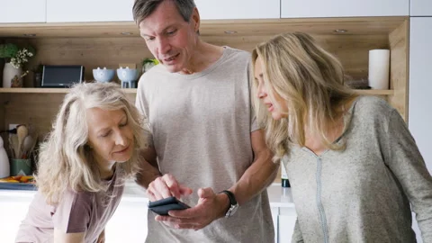 Mid-shot front view of diverse group of coworkers chatting and looking at Stock Footage 278043300