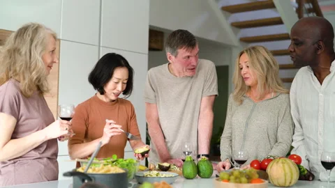 Mid-shot front view of diverse group of coworkers chatting and looking at Stock Footage 278043638
