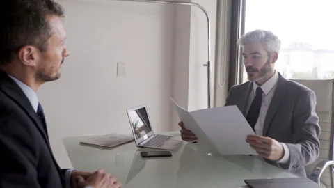 Mid-shot front view of lawyer going over terms of contract while giving legal Stock Footage 277971877