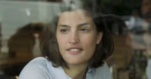 Mid-shot front view of nomad worker looking through window while taking a break Stock Footage 277965292