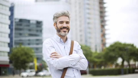 Mid-shot front view of professional man standing with arms crossed while Stock Footage 277975112