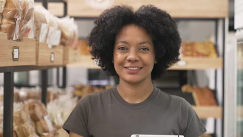 Mid-shot front view shot of young African American female business owner looking Stock Footage 277958072
