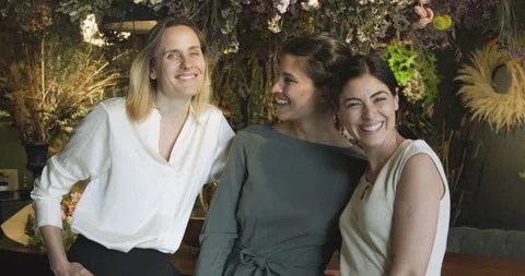 Mid-shot front view of three cheerful young women looking at camera while having Stock Footage 277966718