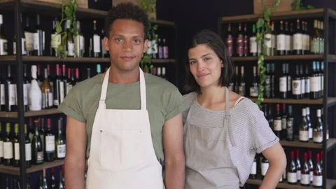 Mid-shot front view of two proud small business owners standing inside their Vídeo Stock 277963962
