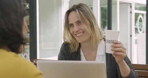 Mid-shot front view of two digital nomad coworkers using laptop while working Stock Footage 277965375