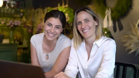 Mid-shot front view of two cheerful digital nomad coworkers doing remote work Stock Footage 277966350