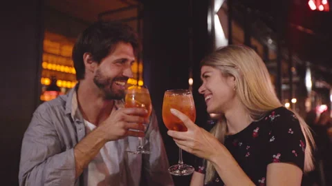 Mid-shot front view of young couple having a good time while having a drink at Stock Footage 277970730