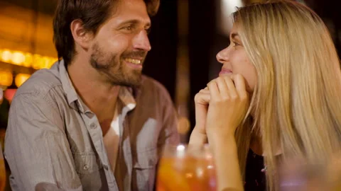 Mid-shot front view of young newlyweds having drinks while enjoying a night out Stock Footage 277970872
