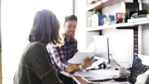 Mid-shot front view of young Asian American business manager giving presentation Stock Footage 277975437