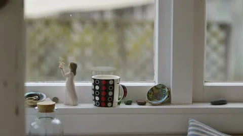 Mid-shot of a hot drink steaming on a window sill. Stock Footage 137980211