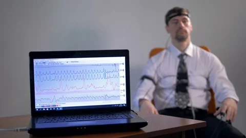Mid shot of the lie detector diagram at the laptop's screen. 4K. Stock Footage 77128080