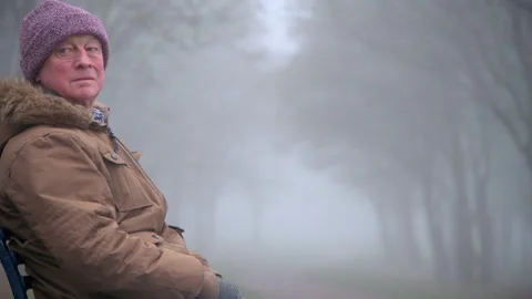 Mid Shot: Lonely Elderly Man Sitting Alone in Park Stock Footage 147894995