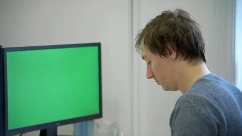 Mid Shot of Man Working At Green Screen Computer Stock Footage 89617703