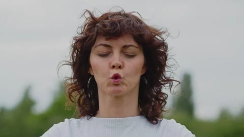 Mid shot of pretty lady doing breathing exercise with closed eyes. Sports Stock Footage 253624119